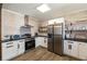 Well-equipped kitchen with stainless steel appliances, white cabinets, and a stylish backsplash at 915 Homer Rd, Woodstock, GA 30188