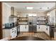 Bright kitchen featuring stainless steel appliances, ample counter space, and open shelving at 915 Homer Rd, Woodstock, GA 30188