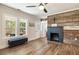 Cozy living area featuring a decorative fireplace and bright windows with natural light at 915 Homer Rd, Woodstock, GA 30188