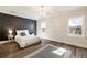 Serene main bedroom featuring a stylish accent wall, hardwood floors, and ample natural light at 915 Homer Rd, Woodstock, GA 30188