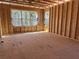 Unfinished bedroom with stud walls and two large windows offering natural light and potential views at 2585 Governors Walk Blvd, Snellville, GA 30078