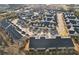 Aerial view of an attractive neighborhood showcasing a dense layout of townhomes with black roofs and pristine landscaping at 334 Cherokee Station Cir, Woodstock, GA 30188