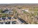 Aerial shot of a neighborhood with townhomes surrounded by trees and commercial spaces, showcasing accessible living at 334 Cherokee Station Cir, Woodstock, GA 30188