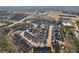 This aerial view captures a neatly organized community of townhomes near commercial areas and a peaceful wooded area at 334 Cherokee Station Cir, Woodstock, GA 30188