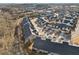 The aerial view shows closely situated townhomes featuring dark roofs, manicured lawns, and a pond, offering a serene community setting at 334 Cherokee Station Cir, Woodstock, GA 30188