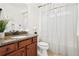 Bathroom with granite vanity, updated fixtures, and shower/tub combination with curtain at 334 Cherokee Station Cir, Woodstock, GA 30188