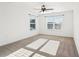 Bright bedroom features neutral walls, carpet, ceiling fan, and large windows providing natural light at 334 Cherokee Station Cir, Woodstock, GA 30188