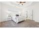 This serene bedroom boasts a tray ceiling and adjacent bathroom with a glass shower at 334 Cherokee Station Cir, Woodstock, GA 30188