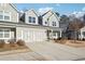 Attractive townhouse with a roomy two-car garage, a well-maintained lawn, and a welcoming front porch at 334 Cherokee Station Cir, Woodstock, GA 30188