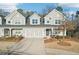 Charming townhouse with a two-car garage, neutral gray siding, and well-maintained landscaping at 334 Cherokee Station Cir, Woodstock, GA 30188