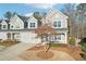 Charming gray townhome with attached garage and professionally landscaped front yard at 334 Cherokee Station Cir, Woodstock, GA 30188