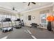 Well-equipped fitness center with treadmills, stationary bike, weights, and ample natural light at 334 Cherokee Station Cir, Woodstock, GA 30188