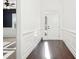 Bright foyer with dark hardwood floors, white walls with paneling, and a view into other rooms at 334 Cherokee Station Cir, Woodstock, GA 30188