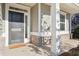 Inviting front porch with a dark front door, neutral siding and brick accents at 334 Cherokee Station Cir, Woodstock, GA 30188