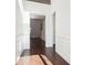 Hallway with dark hardwood floors and white walls with decorative paneling at 334 Cherokee Station Cir, Woodstock, GA 30188