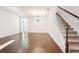 Hallway with staircase and hardwood floors leading into other rooms at 334 Cherokee Station Cir, Woodstock, GA 30188
