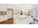 Bright kitchen features white cabinets, granite countertops, stainless steel appliances, and hardwood floors at 334 Cherokee Station Cir, Woodstock, GA 30188
