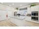 Bright kitchen features a large island with a stone countertop, stainless appliances, and white cabinetry at 334 Cherokee Station Cir, Woodstock, GA 30188