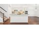 Open kitchen with white cabinets, island and granite countertops at 334 Cherokee Station Cir, Woodstock, GA 30188