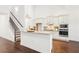 Bright kitchen features white cabinets, granite countertops, stainless steel appliances, and hardwood floors at 334 Cherokee Station Cir, Woodstock, GA 30188