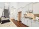 Bright kitchen features white cabinets, granite countertops, stainless steel appliances, and hardwood floors at 334 Cherokee Station Cir, Woodstock, GA 30188