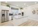 This spacious kitchen boasts an island with stone countertops, tile floors, and stainless steel appliances at 334 Cherokee Station Cir, Woodstock, GA 30188