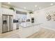 Kitchen with island, stainless steel refrigerator, wall oven, granite counters and wooden floor at 334 Cherokee Station Cir, Woodstock, GA 30188