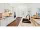 Bright kitchen features white cabinets, granite countertops, stainless steel appliances, and hardwood floors at 334 Cherokee Station Cir, Woodstock, GA 30188