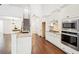 Bright kitchen features white cabinets, granite countertops, stainless steel appliances, and hardwood floors at 334 Cherokee Station Cir, Woodstock, GA 30188