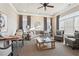 Cozy living room featuring neutral walls, crown molding, large windows, and comfortable seating at 334 Cherokee Station Cir, Woodstock, GA 30188