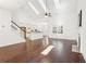 Spacious living room featuring vaulted ceilings, skylights, hardwood floors, and a view into the kitchen at 334 Cherokee Station Cir, Woodstock, GA 30188