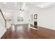 Open-concept living room featuring vaulted ceilings, skylights, hardwood floors, and a cozy fireplace at 334 Cherokee Station Cir, Woodstock, GA 30188