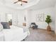 Bright main bedroom features a ceiling fan, neutral tones, and plush carpet at 334 Cherokee Station Cir, Woodstock, GA 30188