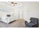 Inviting main bedroom features a ceiling fan, neutral tones, and plush carpet at 334 Cherokee Station Cir, Woodstock, GA 30188