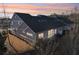 Rear exterior view shows architectural details, outdoor living spaces, and professional landscaping at 334 Cherokee Station Cir, Woodstock, GA 30188
