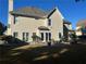 Back of the home showing large windows, lush landscaping, and patio with seating area at 3381 Walkers Ridge Rd, Dacula, GA 30019