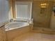 Bright bathroom featuring a soaking tub and glass enclosed walk-in shower at 3381 Walkers Ridge Rd, Dacula, GA 30019