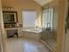 Bright bathroom with walk-in shower, tub, and vanity area with white cabinets and granite countertops at 3381 Walkers Ridge Rd, Dacula, GA 30019