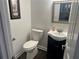 Small half bathroom with a pedestal sink, framed artwork, and tiled flooring at 3381 Walkers Ridge Rd, Dacula, GA 30019