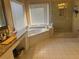 Bright bathroom with walk-in shower, soaking tub, and vanity area with granite countertops at 3381 Walkers Ridge Rd, Dacula, GA 30019