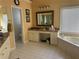 Bright bathroom with soaking tub, and vanity area with granite countertops at 3381 Walkers Ridge Rd, Dacula, GA 30019