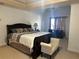 Large bedroom featuring trey ceiling, spacious bed, dresser, and chair with window at 3381 Walkers Ridge Rd, Dacula, GA 30019