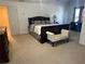 Spacious Primary bedroom featuring neutral carpet, large bed, side tables, and dresser at 3381 Walkers Ridge Rd, Dacula, GA 30019