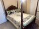 Cozy bedroom with four poster bed, decorative pillows and comforter, with doors and carpeted floor at 3381 Walkers Ridge Rd, Dacula, GA 30019