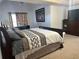 Spacious bedroom with neutral carpet, large bed, side table, and television cabinet at 3381 Walkers Ridge Rd, Dacula, GA 30019