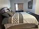 Comfortable bedroom featuring a spacious bed, and dresser with a mirror and natural lighting at 3381 Walkers Ridge Rd, Dacula, GA 30019
