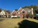 Charming brick home with well-manicured lawn and landscaping on a sunny day, situated on a spacious lot at 3381 Walkers Ridge Rd, Dacula, GA 30019