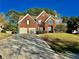 Beautiful two-story brick home with attached two-car garage, long driveway, and landscaped front yard at 3381 Walkers Ridge Rd, Dacula, GA 30019