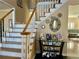 Inviting foyer with a staircase featuring white railings, hardwood floors, and stylish decor at 3381 Walkers Ridge Rd, Dacula, GA 30019