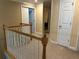 Upstairs hallway with neutral walls, crown molding, wooden railings and access to multiple rooms at 3381 Walkers Ridge Rd, Dacula, GA 30019